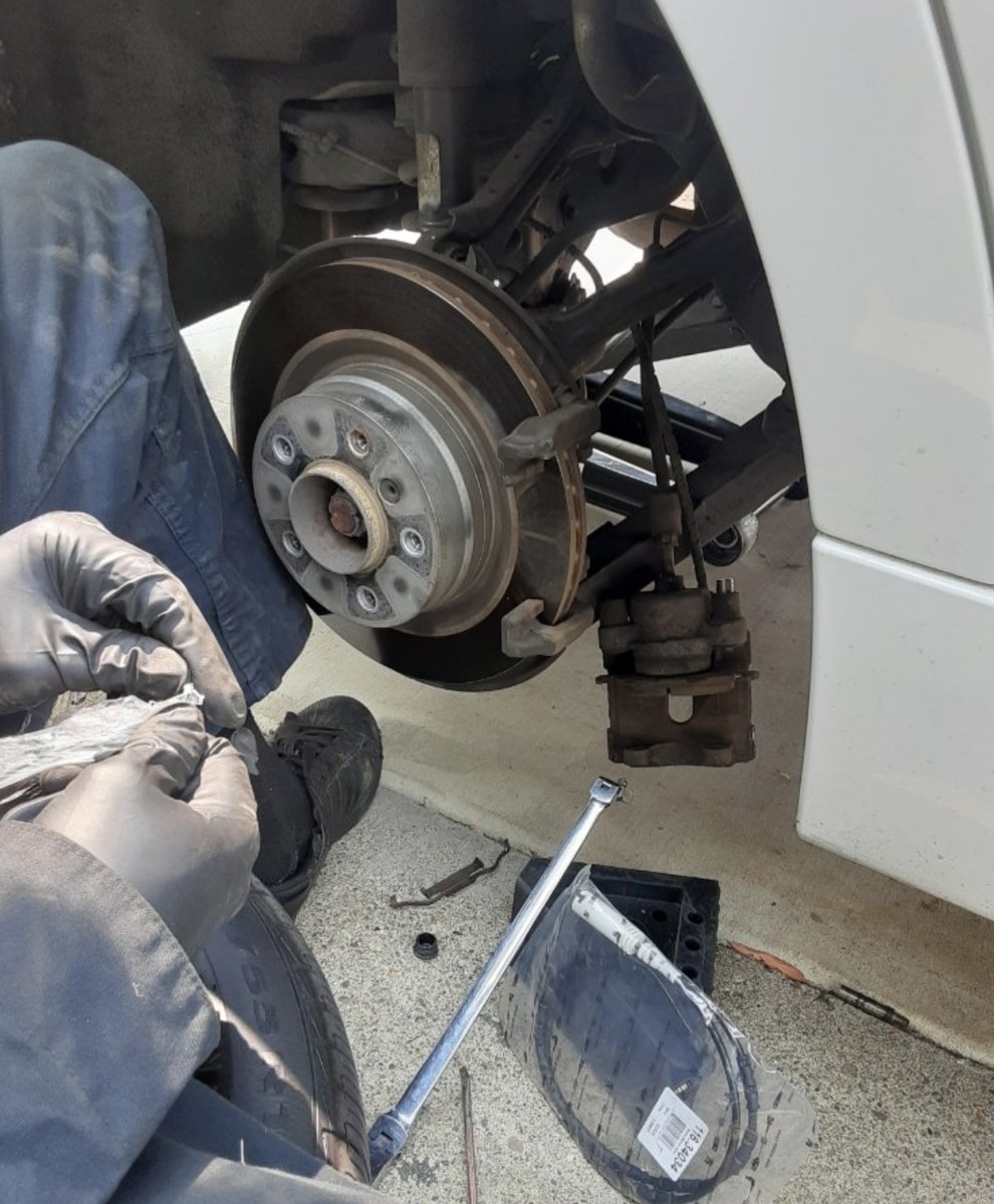 Wheel off and caliper out during a Westminster brake repair